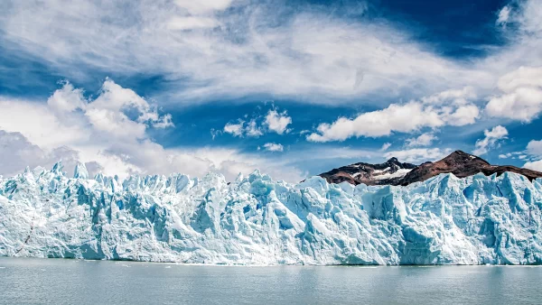 Glacier landscape in Patagonia with ice front and mountain backdrop